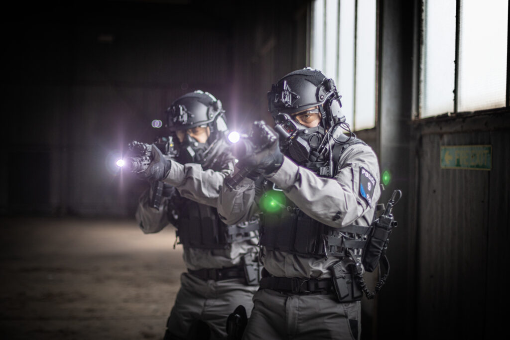 Soldiers wearing tactical protective equipment during low-light firearms training