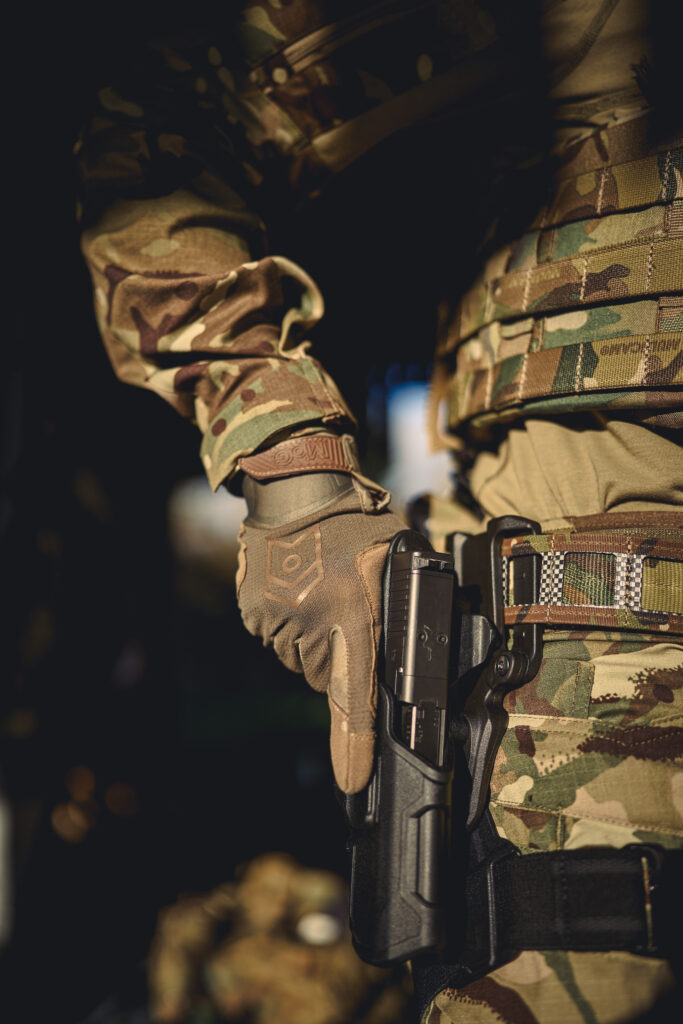 operator wearing body armour and tactical load carriage equipment