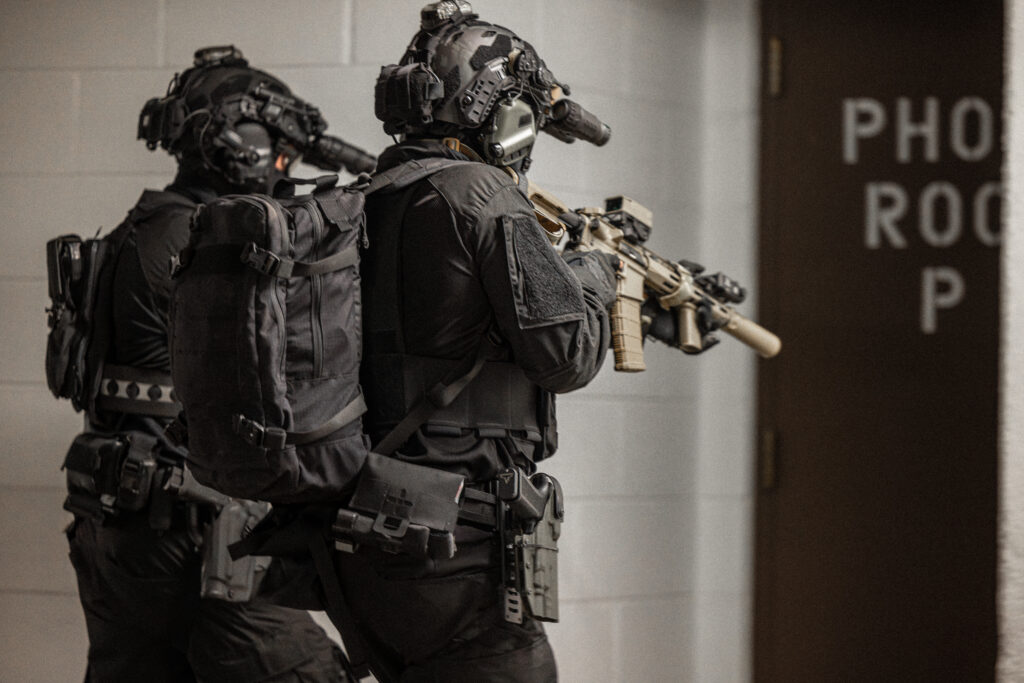 Soldiers wearing integrated tactical equipment and protective systems during an urban operation