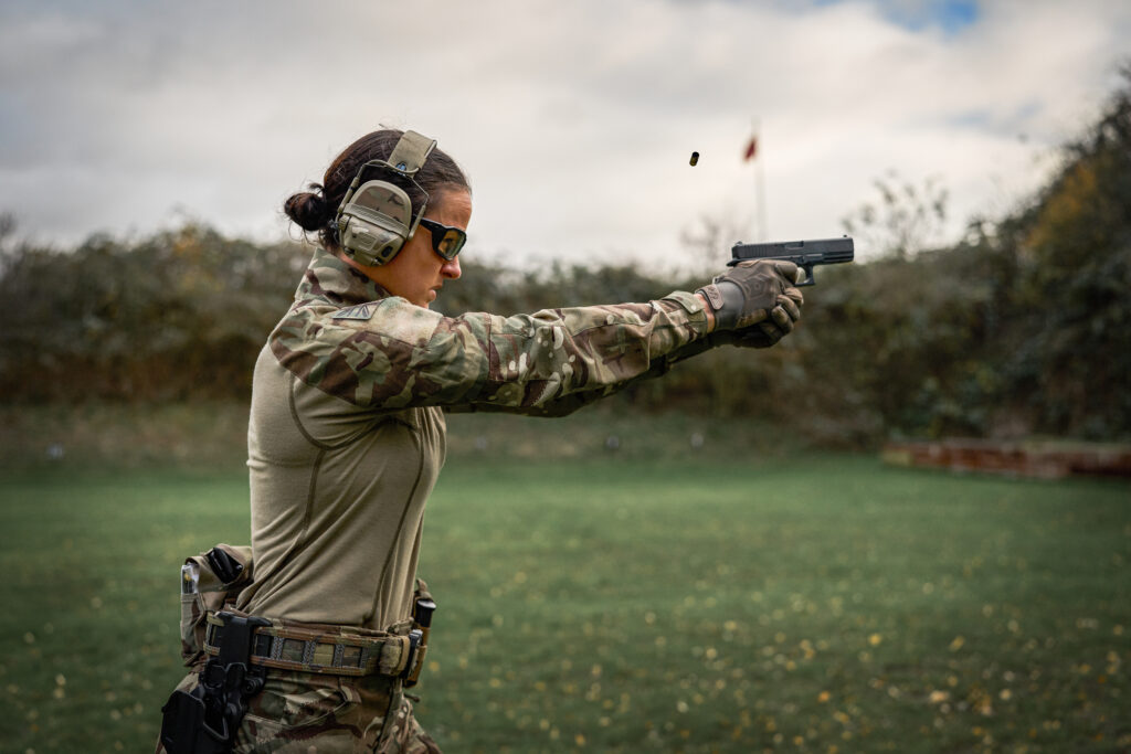 Soldier wearing tactical hearing protection and communications equipment during firearms training